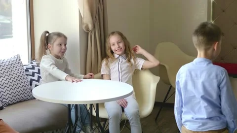 Children in the cafe play different games. Children have fun in the cafe waiting Stock Footage 154450127