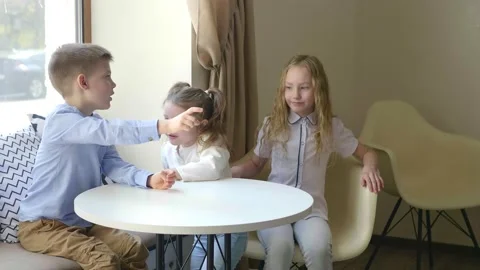 Children in the cafe play different games. Children have fun in the cafe waiting Stock Footage 154450209
