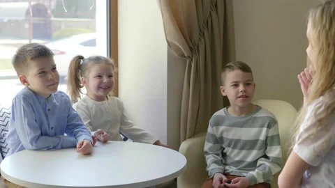 Children in the cafe play different games. Children have fun in the cafe waiting Stock Footage 154450318