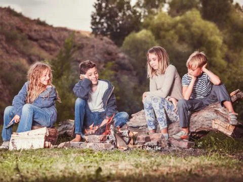 Children in the camp by the fire Stock Photos