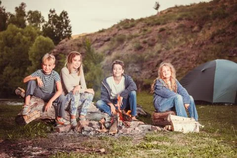 Children in the camp by the fire Stock Photos