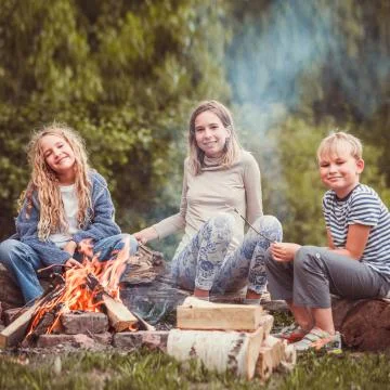 Children in the camp by the fire Stock Photos