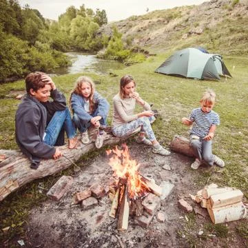 Children in the camp by the fire Stock Photos