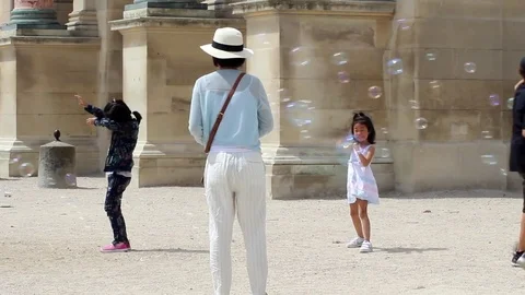 Children chasing bubbles Stock Footage 78483631