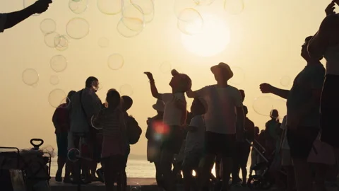 Children chasing soap bubbles Stock Footage 340627649