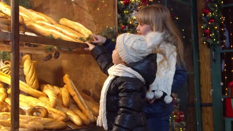 Children choosing bread in bakery in evening Stock Footage 143504462