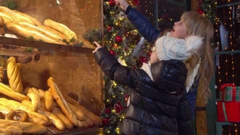 Children choosing bread in bakery in evening Stock Footage 143508202