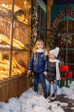Children choosing bread in bakery in evening Stock Photos
