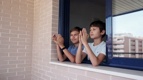 Children clapping hands, applauding from window to support doctors Stock Footage 131292890