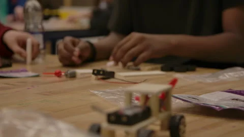 Children in class working on STEM motorized cars Stock Footage 283668855