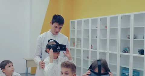 Children in the classroom look in virtual reality glasses Stock Footage 86156513