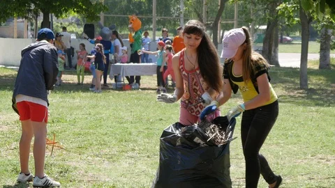 Children clean Garbage in the Park during an Environmental Campaign Stock Footage 108386952