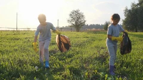 Children collect garbage in a bag. Stock Footage 120731759