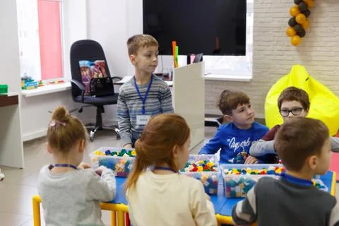 Children collect various objects from plastic parts of the constructor Fotos Stock