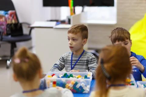 Children collect various objects from plastic parts of the constructor Fotos Stock