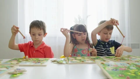 Children concentrate on the creative task of melting pictures. Stock Footage 276921305