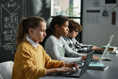 Children concentrating on online work on computers Stock Photos