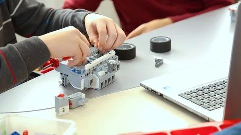 Children construct and programm robots. Editorial use only Video stock 87036576