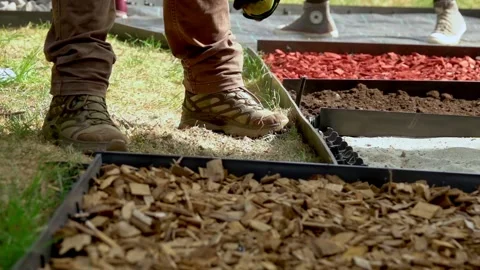 Children constructing a path, in the sensory garden, made  of diferent materials 動画素材 139742926