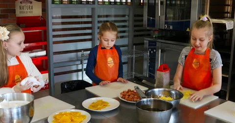 Children cook in a large professional equipped kitchen Stock Footage 139536780