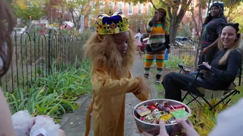 Children in costume trick-or-treating in a front garden on Capitol Hill Stock Footage 345299539