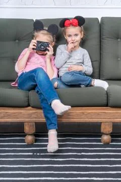 Children on the couch with a camera Stock Photos