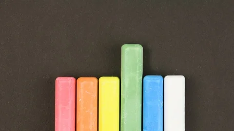 Children crayons on black background in row, come out sequentially, stopmotion Stock-Footage 106553150