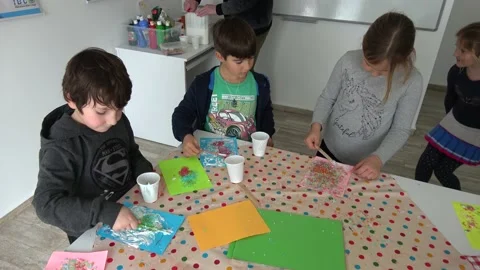 Children create in class doing application work with painted grains 스톡 동영상 147741074