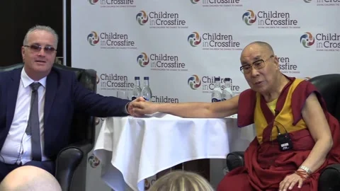 Children in Crossfire director sits down with the Dalai Lama Stock Footage 148667150