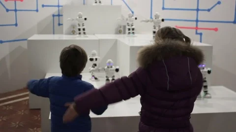 Children dance with funny white robots Stock Footage 71937117