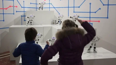 Children dance with funny white robots Stock Footage 71937239
