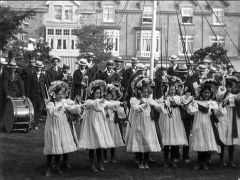 Children dancing around a maypole at Well Dressing celebration, Buxton UK 1904 Stock Footage 136672955