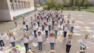 Children Dancing Flash Mob With The Flag Of Ukraine, Aerial Stock Footage
