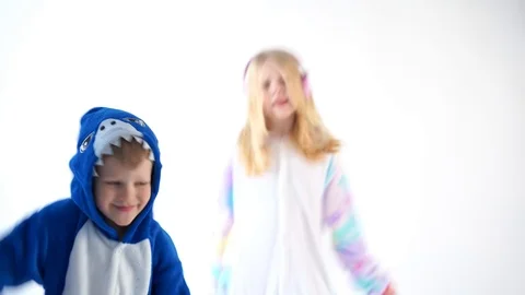 Children dancing fun on a white background in pajamas kigurumi Stock Footage 101304870