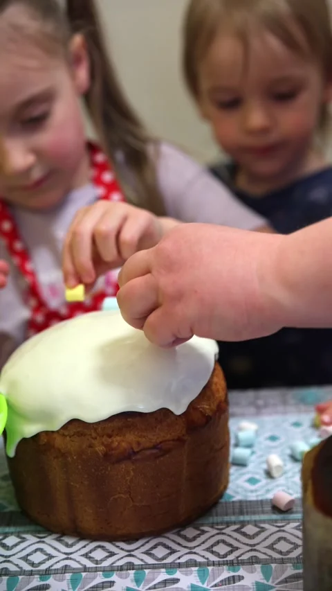 Children Decorating Easter Kulich with Colorful Sprinkles Stock-Footage 333010258