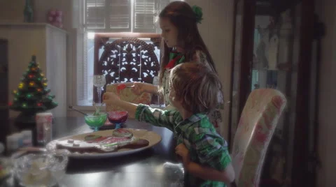Children decorating ginger bread man at christmas 4k Stock Footage 66453144