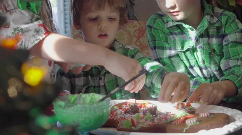 Children decorating ginger bread man at christmas 4k Stock Footage 66455332