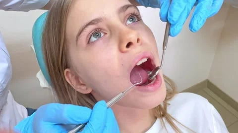 Children dentistry. Hands of unrecognizable pediatric dentist making examination Stock Footage 268976832