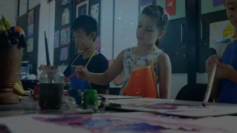 Children dipping brushes and mixing colorful paints for abstract patterns at art Stock Footage 327128607
