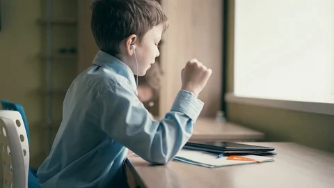 Children do their homework, one sits at the table with notebooks Stock Footage 105099907