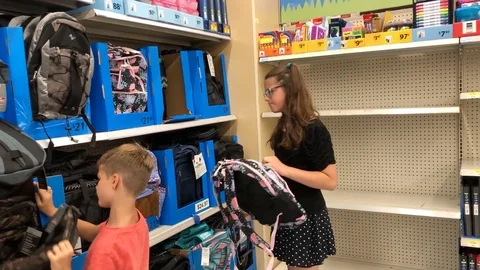 Children doing back to school shopping in store Stock Footage 92925916