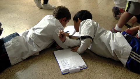 Children Doing Homework in School Hallway During Recess, Argentina - 4K Video stock 318988355