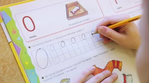 Children draw and write the letters in the notebook perform tasks Stock Footage 55571843