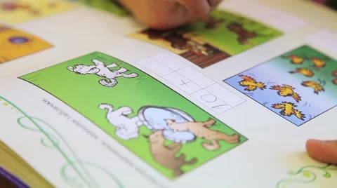 Children draw and write the letters in the notebook perform tasks Stock Footage 55571870