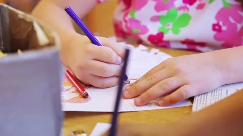 Children draw and write the letters in the notebook perform tasks Stock Footage 55571930