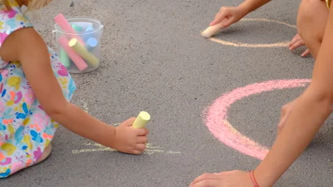 Children draw on the asphalt with chalk. Elective focus. Stock Footage 293337165