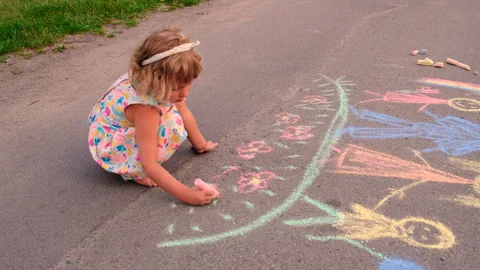 Children draw on the asphalt with chalk. Selective focus. Stock Footage 295866609