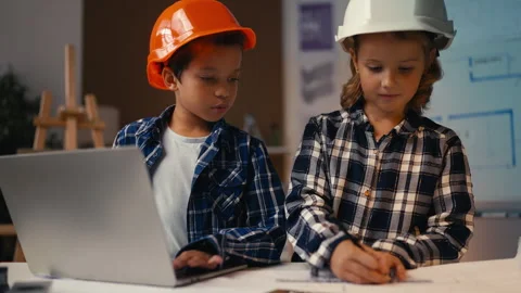 Children draw a blueprint and type on laptop, prepare a school project together Stock Footage 277899663