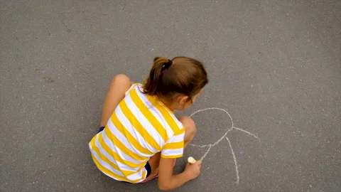 Children draw with chalk on the asphalt. Selective focus. Stock Footage 161620573