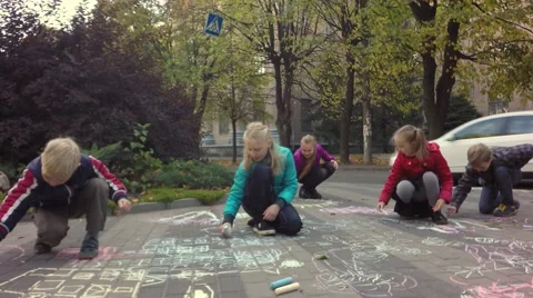 Children draw with chalk on the pavement. Video stock 68763507